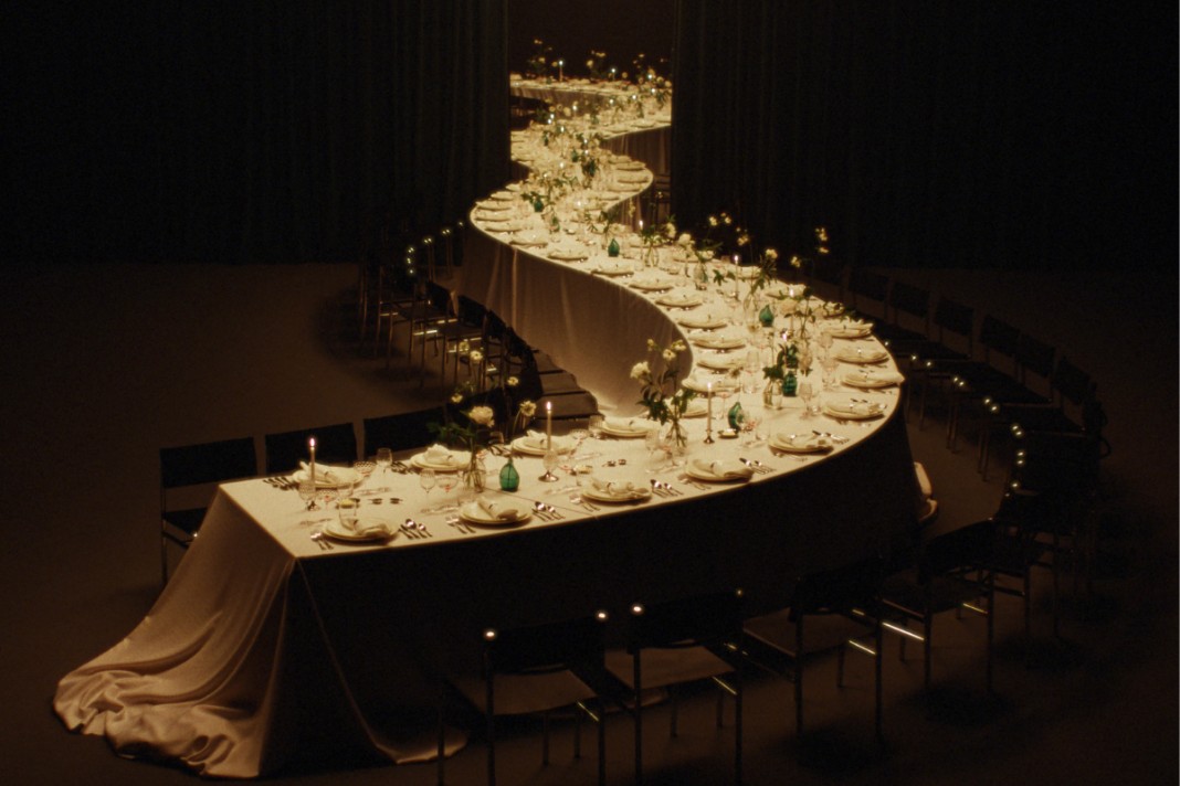 Long curved table with Victoria Beckham's dinnerware on display
