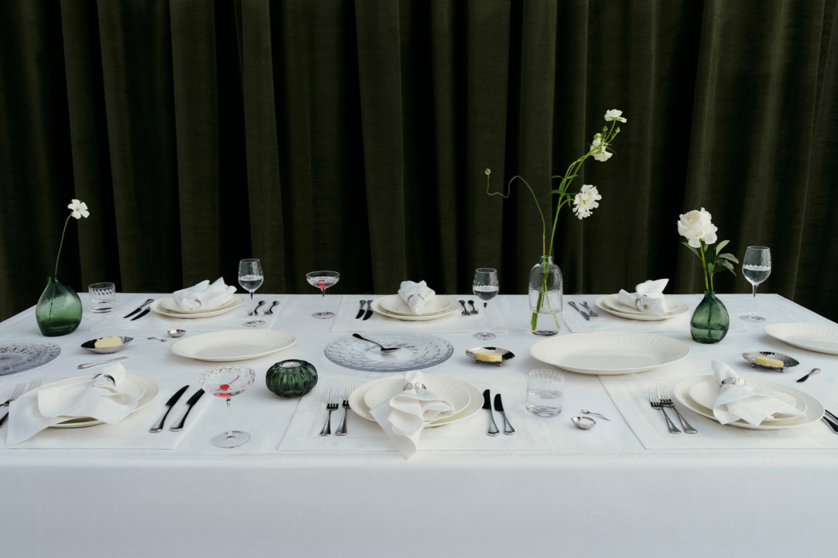 White table cloth with green glassware shows Victoria Beckham's new collection