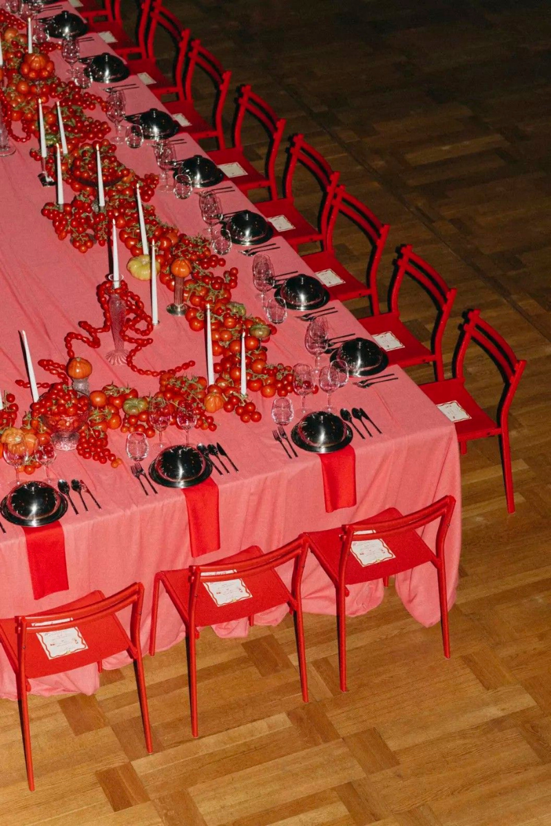 Red monochrome table with fruit and metallic plates