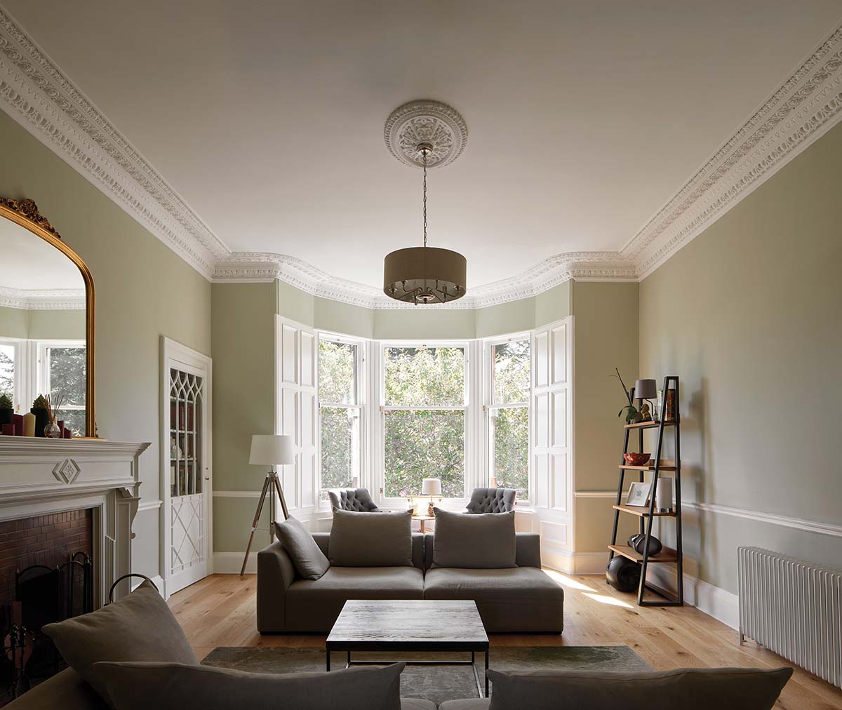 modern sleek living room in an edinburgh victorian villa with a white couch and pale avocado walls